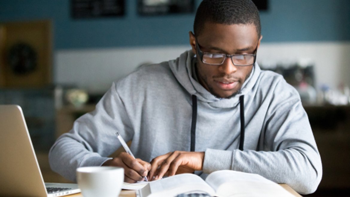 Student working on his own device in a coffee shop
