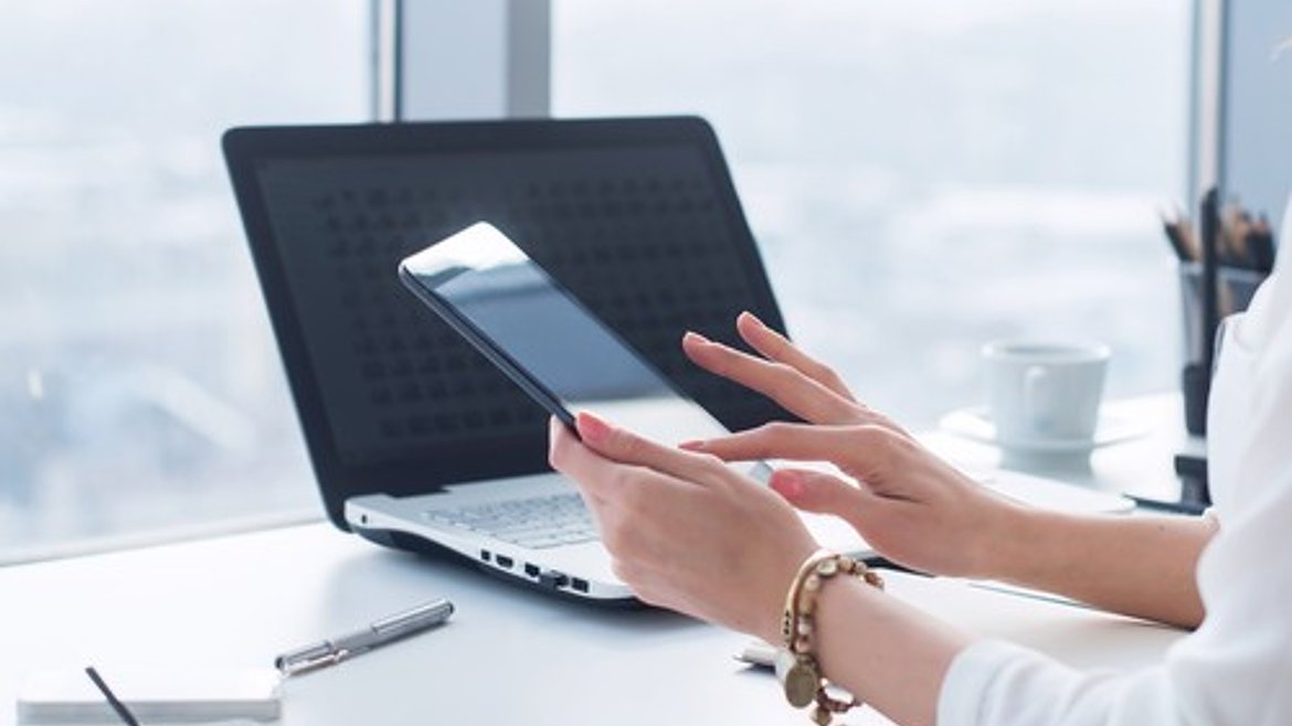 Woman using personal devices to access university software